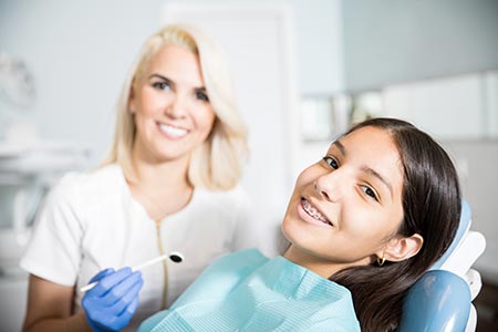 dentist and adolescent at appointment